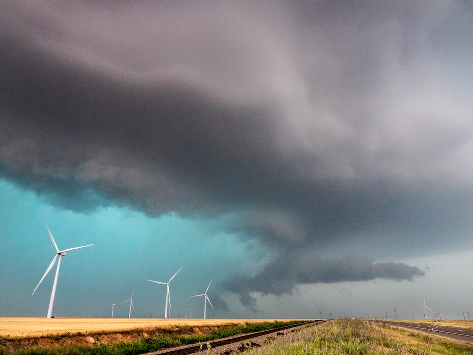 High-precipitation supercell thunderstorm over a wind farm near Oklaunion, Texas — the rotating storm structure typical of the severe spring weather that crosses Montague County